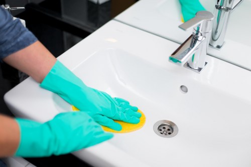 Cleaner working on kitchen surfaces during a deep cleaning service