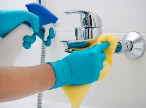 Technician cleaning a sofa in a Clapham flat with careful fabric care